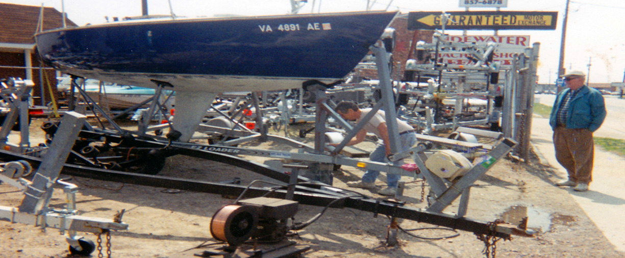 bob working on a sailboat trailer