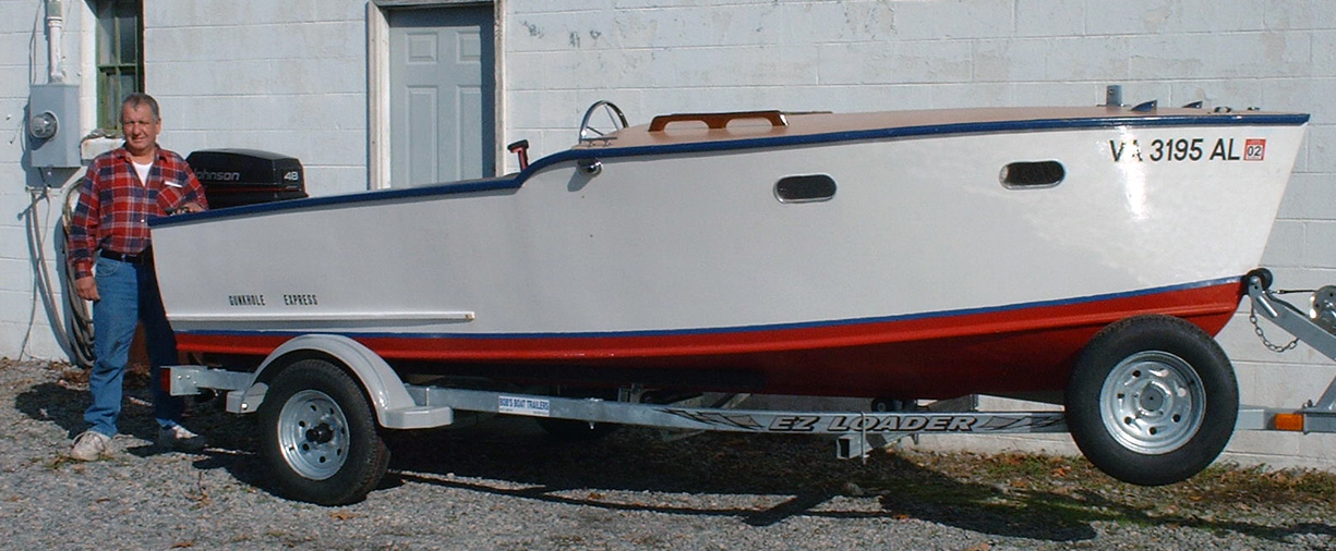 bob standing near a boat trailer with a boat on it