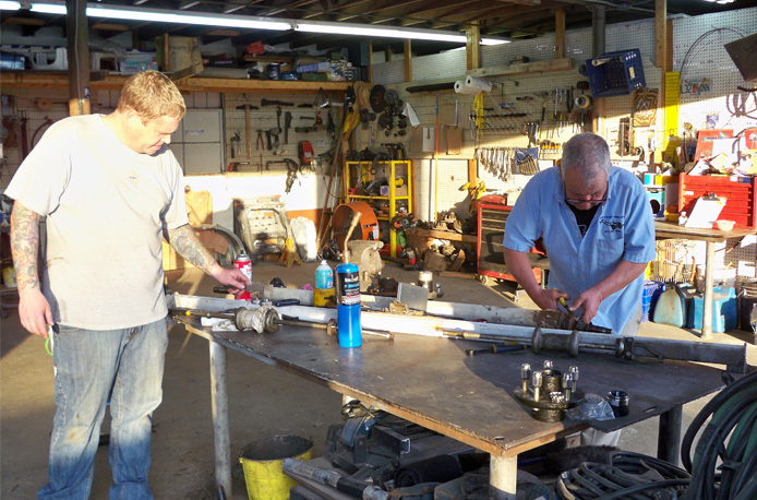 Image of Bob and Chris repairing an axle