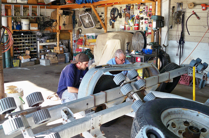 Image of Bob and Josh relacing a fender